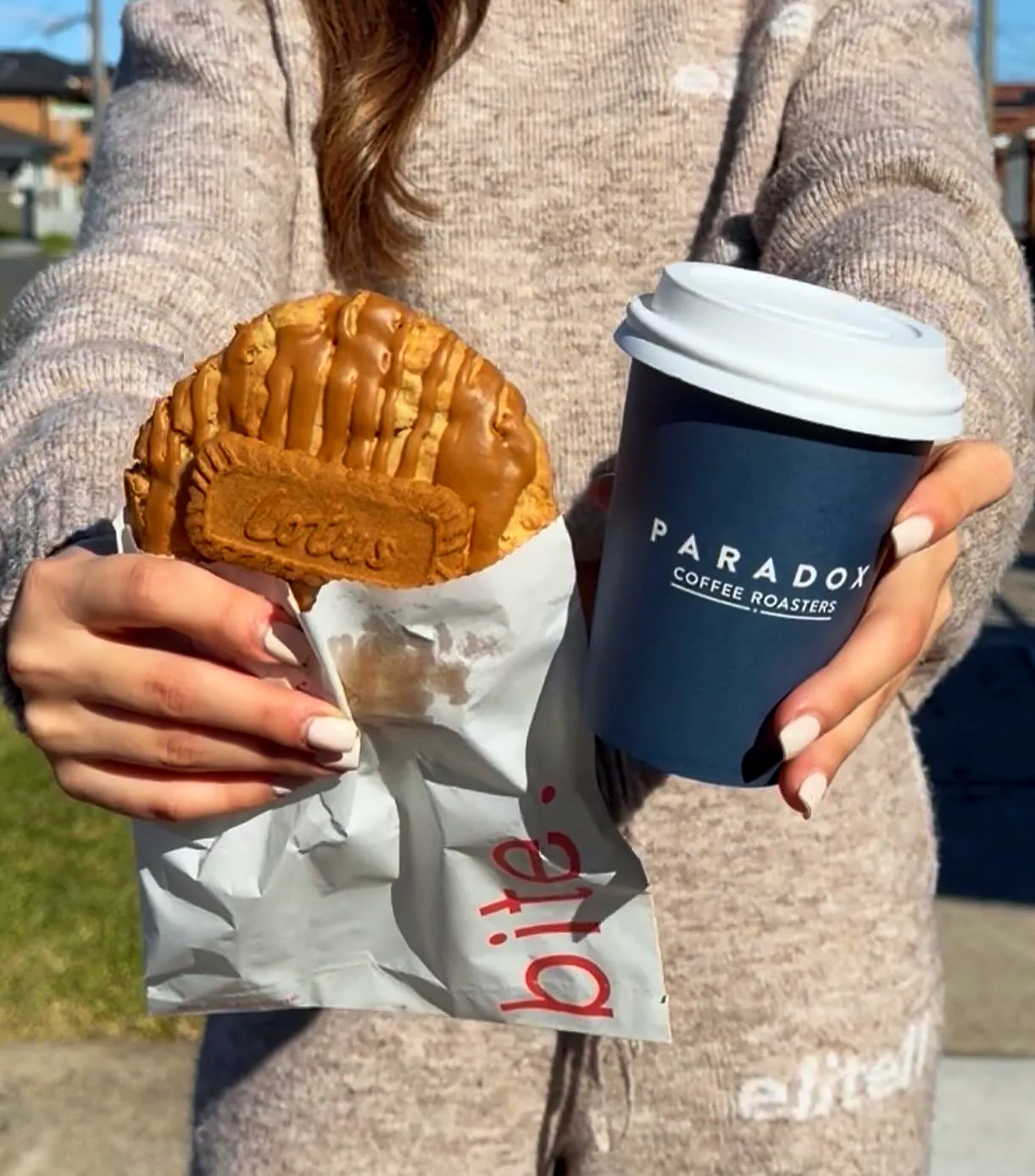 A coffee in a Paradox cup and a cookie