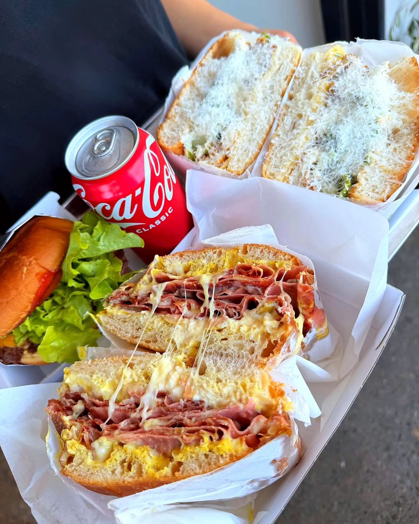 Two focaccias cut open in deli paper